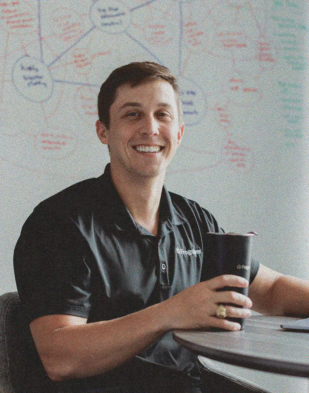An engineer at a whiteboard covered in diagrams